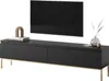 A black TV lowboard with gold legs, a television mounted above it, and decorative items on top.