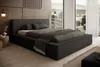A modern bedroom with a large bed, wooden wall paneling, and large windows overlooking a landscape. Voir les images du produit