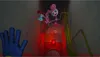 A scene from a video game with a large pink spider-like character and a smaller doll. Náhled obrázku produktu