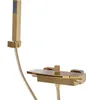 A gold-colored shower faucet set with a handheld showerhead, mounted on a white background. Podgląd zdjęcia produktu