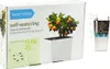 The image shows the packaging for a self-watering planter system, featuring a diagram of the planter and a picture of a small orange tree in the planter. Náhľad obrázku produktu