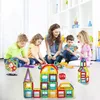 A group of children and an adult are playing with magnetic building blocks on the floor. Náhled obrázku produktu
