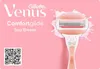 A pink background with a Gillette Venus ComfortGlide Spa Breeze razor and text. Voir les images du produit