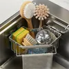 A kitchen sink corner organizer with various cleaning supplies. Produktbild-Vorschau