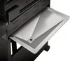 A close-up view of a stainless steel drip tray on a gas grill. Produktbild-Vorschau