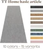 A long runner rug in a light gray color is shown diagonally, with a selection of 10 different color swatches displayed vertically to the right. The text "TT-Home basic article" is at the top, and "10 colors - 15 variants" is at the bottom. Produktbild-Vorschau