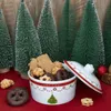 A Christmas-themed cookie tin filled with various cookies, surrounded by miniature artificial Christmas trees. Anteprima dell’immagine prodotto