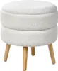 A white, textured ottoman with wooden legs is shown against a white background. Náhled obrázku produktu