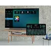 A keyboard and TV setup in a living room. Náhľad obrázku produktu