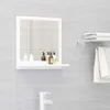A bathroom mirror with a shelf and toiletries, mounted on a tiled wall. Produktbild-Vorschau