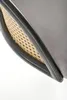 A close-up view of the side of a chair, showing the woven cane material and the upholstered seat. Podgląd zdjęcia produktu
