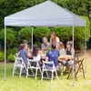 People are gathered around a table under a white pop-up canopy in a garden setting. Náhľad obrázku produktu