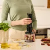 A person is using a Braun hand blender to prepare ingredients in a kitchen. Anteprima dell’immagine prodotto