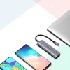 A USB-C hub is shown connected to a laptop, with two smartphones nearby, suggesting connectivity and versatility. Produktbild-Vorschau