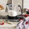 A digital kitchen scale with a measuring jug filled with flour is shown on a marble countertop, with raspberries and a whisk nearby. Náhľad obrázku produktu