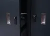 Close-up view of two open doors of a dark gray storage unit, revealing locks and handles. Náhled obrázku produktu