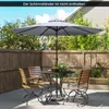 An outdoor patio scene with a table, chairs, and an umbrella. Produktbild-Vorschau