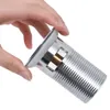 A hand is holding a silver drain fitting. Podgląd zdjęcia produktu