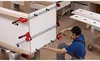 A man is using clamps to assemble a cabinet in a workshop. Voir les images du produit