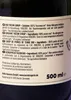 A close-up of a dark glass bottle with a label showing product information in multiple languages. Produktbild-Vorschau