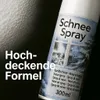 A spray can of snow spray with a winter scene on the label, placed against a dark, textured background. Text is overlaid on the left side of the image. Produktbild-Vorschau