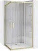 A shower enclosure with gold-colored frames and clear glass doors, set against a gray tiled wall. Produktbild-Vorschau
