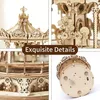 A collage of four close-up images showcasing the intricate details of a wooden carousel model. Anteprima dell’immagine prodotto