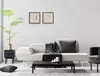 A modern living room scene with a sofa, coffee table, and decorative items. Náhled obrázku produktu