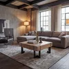 A living room scene with a sectional sofa, coffee table, armchair, and floor lamp. Voir les images du produit