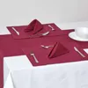 A table setting with two place settings, each featuring a placemat, napkin, and cutlery, arranged on a white tablecloth. Náhled obrázku produktu