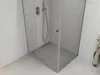 A modern shower enclosure with a glass door and a linear drain on the floor. Podgląd zdjęcia produktu