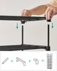 A close-up of someone assembling a black shoe rack. Produktbild-Vorschau