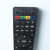 A close-up view of a black remote control with various buttons. Produktbild-Vorschau