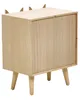A light brown wooden nightstand with a sliding door and four angled legs, set against a white background. The top of the nightstand has small, triangular wooden accents resembling animal ears. Náhled obrázku produktu