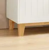 Close-up of the bottom corner of a white cabinet with wooden legs, resting on a wooden floor. Produktbild-Vorschau