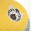 A close-up of a yellow ball with cartoon animal faces printed on it. Produktbild-Vorschau