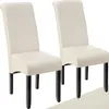 Two cream-colored dining chairs with black legs are shown against a white background. Produktbild-Vorschau