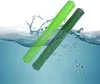 Two green vacuum cleaner brush rolls submerged in water with splashes and bubbles. Produktbild-Vorschau
