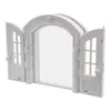 A white arched doorway with two open doors, each with a window pane and a round knob. Náhled obrázku produktu