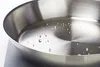 A close-up shot of a stainless steel frying pan with water droplets inside. Produktbild-Vorschau