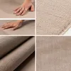 A collage of images showing a beige carpet from different angles, including close-ups of the texture and a hand touching it. Anteprima dell’immagine prodotto