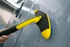 A person is using a yellow and black cleaning brush attachment on a gray surface, possibly a vehicle or building exterior, with water droplets visible. Produktbild-Vorschau