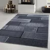 A rug with a wood plank design is shown on a floor, with firewood and a fireplace in the background. Voir les images du produit