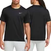 A man wearing a black Nike t-shirt and light grey pants, shown from the front and back. Podgląd zdjęcia produktu