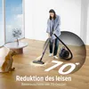 A woman is vacuuming a wooden floor while a dog watches. Text indicates reduced noise levels. Produktbild-Vorschau