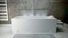 A modern bathroom with a white rectangular bathtub against a textured gray wall. Produktbild-Vorschau