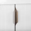 A close-up view of a cabinet with two doors and a bronze handle. Produktbild-Vorschau