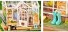 A diorama of a miniature greenhouse with gardening accessories. Anteprima dell’immagine prodotto
