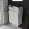 A modern white vanity unit with a sink and black faucet in a bathroom setting. Produktbild-Vorschau