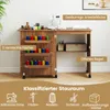 A sewing cabinet and desk combination with various sewing supplies organized within its compartments. Produktbild-Vorschau